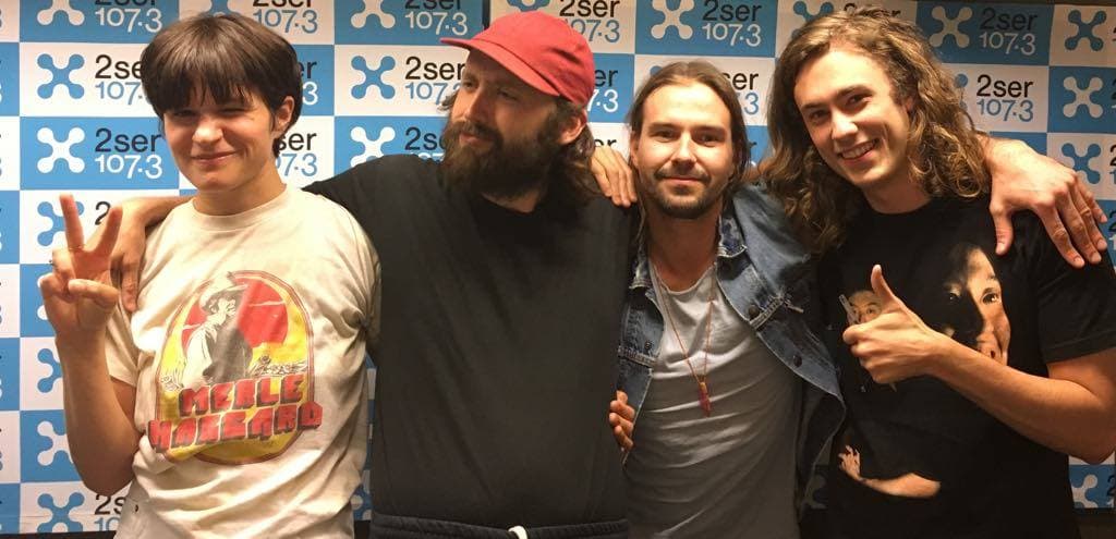 Monday Drive host, Bryce Mills, posing with Brooklyn band, Big Thief