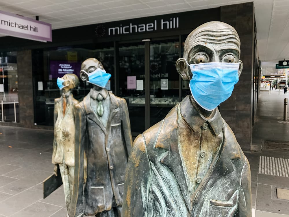 COVID - 4 Years On. Melbourne - 11 August 2020: statues in Downtown Melbourne don facemasks for the pandemic.