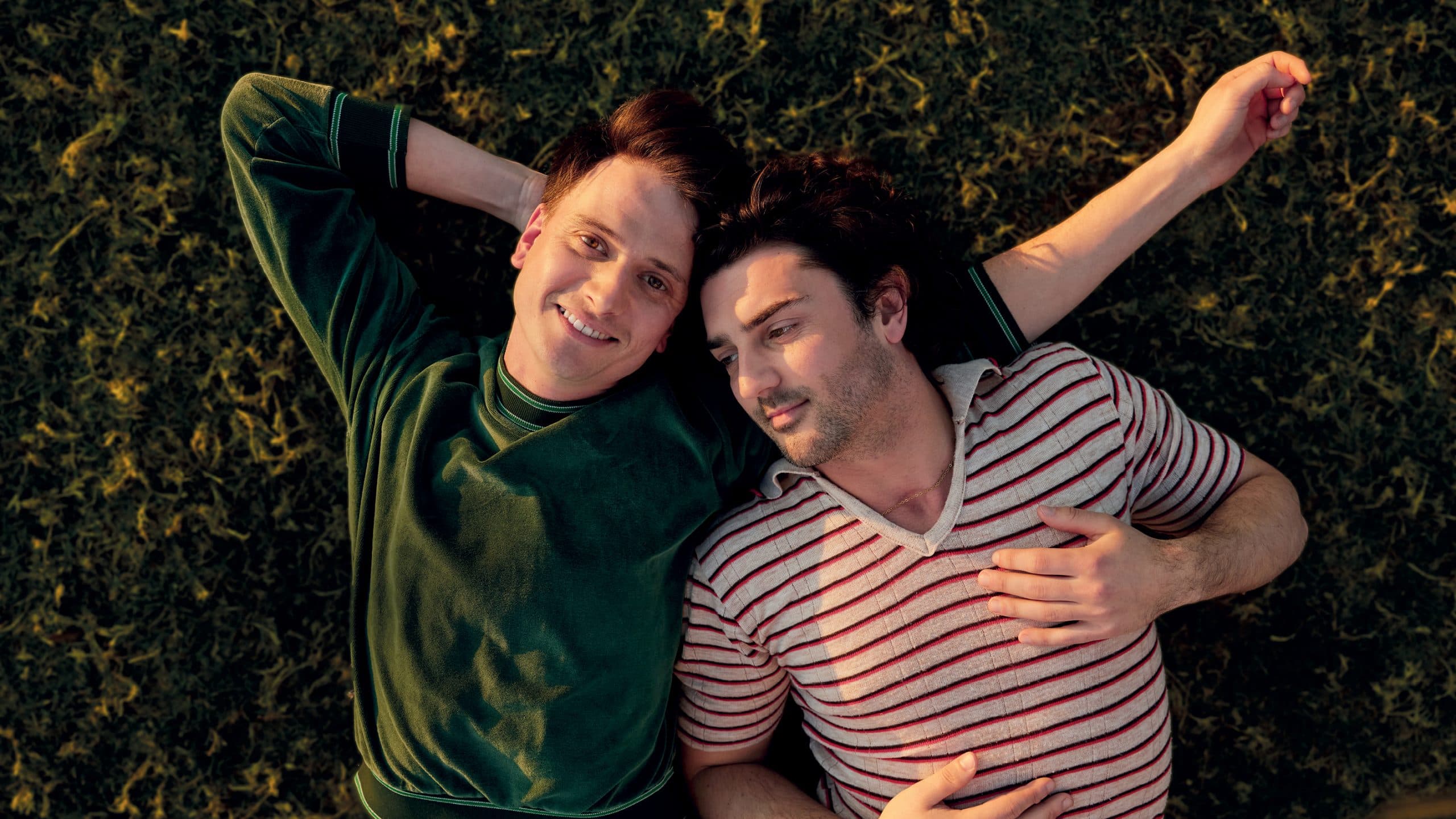 Holding the Man. Gay couple laying on the grass. Two men laying on the grass.