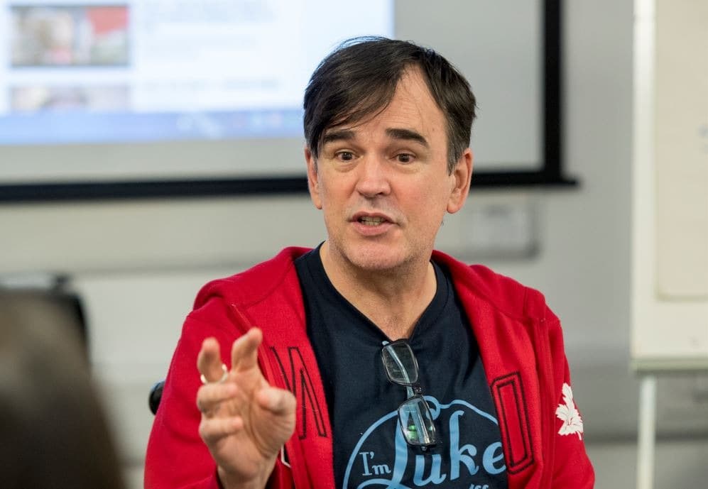 image shows comedy legend Tim Ferguson (of the Doug Anthony Allstars) gesticulating as he teaches comedy